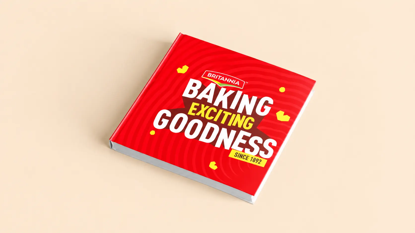 Hardbound brand catalogue — Britannia red with the Baking Exciting Goodness ribbon lockup.